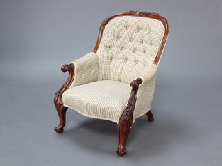 A Victorian carved mahogany show frame armchair upholstered in chequered material raised on cabriole supports 85cm h x 65cm w x 50cm d (seat 36cm x 40cm) 