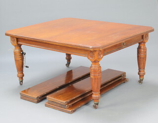 A Victorian mahogany extending dining table with 5 extra leaves, raised on turned and fluted supports, brass caps and ceramic casters, 75cm h x 151cm l when closed x 300cm when fully extended, complete with winder 