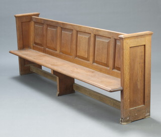 A 19th Century panelled oak church pew, 84cm h x 230cm w x 46cm d (seat 220cm x 29cm), 