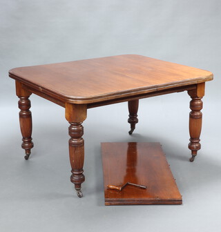 A Victorian mahogany extending dining table raised on turned and reeded supports with 1 extra leaf and winder 73cm h x 114cm w x 126cm l x 176cm l when extended 