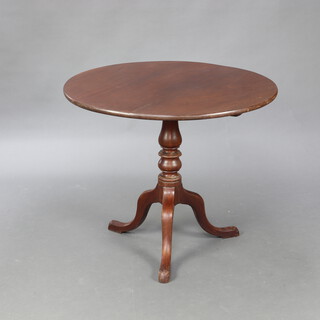 A 19th Century circular mahogany snap top tea table raised on turned column and tripod base 71cm h x 86cm diam.  