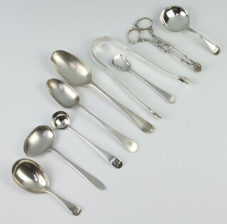 A pair of Georgian silver sugar nips with bright cut decoration and minor spoons, 168 grams 