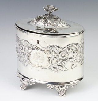 A George III oval repousse silver 2 division tea caddy, raised on shell feet London 1784, maker GS, 12cm, 460 grams