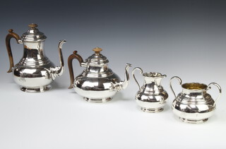 A good 4 piece silver tea and coffee set with fruitwood handles, bearing the family crest of the Davies family of Maesmawr Hall, London 1913, makers Goldsmiths & Silversmiths, gross weight 2372 grams 