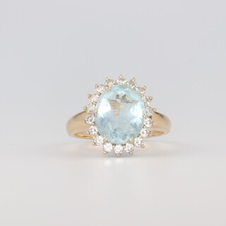 A 14ct yellow gold oval aquamarine and diamond cluster ring, size Q 1/2, 18 diamonds each at 0.03ct, the centre stone 12mm x 10mm, 5.4 grams