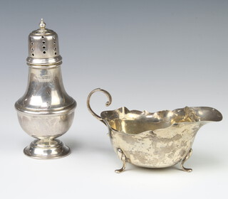 A silver sugar caster Birmingham 1989 15cm, 126 grams and a silver sauce boat (rubbed marks) 84 grams 