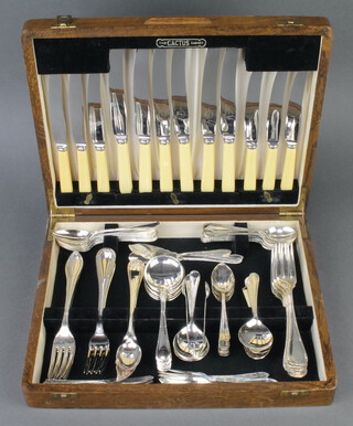 An oak canteen containing a quantity of plated ribbon and bow cutlery 