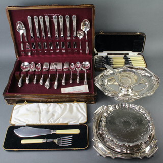 A silver plated swing handled basket, 2 salvers, 2 dishes, lemon strainer and stand, 2 cased sets and a cased canteen 
