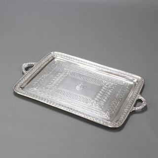 A fine Victorian silver 2 handled tray with cymric pattern handles and border enclosing a duplicate border and a rectangular cartouche, engraved with the family crest of the Davies of Maesmawr Hall, London 1892, makers Goldsmiths and Silversmiths Co. (William Gibson and John Lawrence Langman) 6941 grams (224 ozs), 83.5cm x 50.5cm, contained in the original fitted mahogany box with armorial 