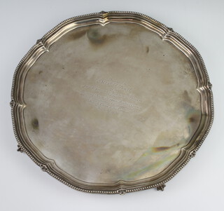 A silver salver with pie crust and bead rim on claw and ball feet with presentation inscription, Sheffield 1921, 1216 grams, 36cm 