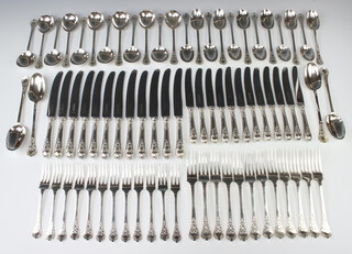 A good canteen of silver trefid cutlery for 12 with lace back detail comprising 12 dessert forks, 12 dinner forks, 12 dessert spoons, 12 soup spoons, 4 serving spoons, London 1963, London 1978, London 1980, maker Garrards & Co Ltd. together with 12 dinner knives with silver handles and 12 dessert knives with silver handles, 2994 grams, together with a mahogany canteen 