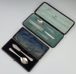 A cased 3 piece silver christening set, Sheffield 1930 with ribbon and bow decoration, ditto butter knife and preserve spoon, weighable silver 80 grams 