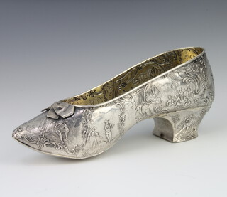 A 19th Century Continental 800 standard repousse shoe decorated with figures and pursuits, with gilt interior 18cm, 168 grams 