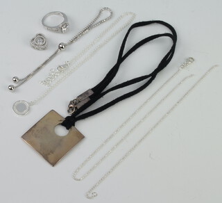 Two silver necklaces, a silver paste dress ring size K 1/2, a silver bracelet and hammered pendant 
