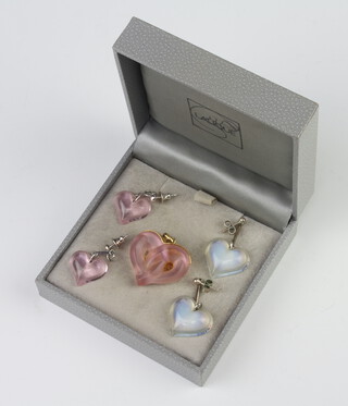 A Lalique pink glass gilt mounted heart shaped pendant 2.5cm, a pair of ditto earrings 1cm and a pair of vaseline ditto 2cm 