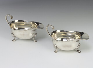 A matched pair of silver sauce boats with beaded rims on shell knees with hoof feet, London 1865 and 1867, 362 grams 