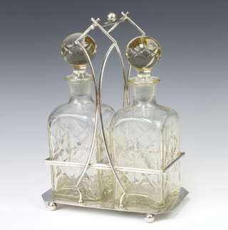 An Art Deco style silver plated 2 bottle decanter holder with moulded decanters 30cm 