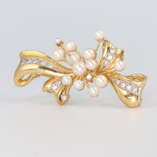 An 18ct yellow gold diamond and seed pearl ribbon brooch 8.1 grams, 38mm long 