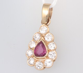 A Victorian style yellow metal pear shaped pendant with pear cut ruby and 10 brilliant cut diamonds, the ruby approx. 0.5ct, the diamonds each approx. 0.10ct, 2.6 grams, 26mm x 14mm 
