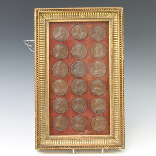 Eighteen repousse copper medallions depicting Kings and Queens of England, framed as one 