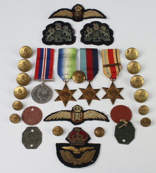 A World War Two group of medals comprising 1939-45 Africa Star with North Africa 1942-43 bar, Atlantic Star and War medal together with a set of dog tags W H Russell RNZAF 40987, another pair to J W Price RAF and minor cloth badges and buttons 