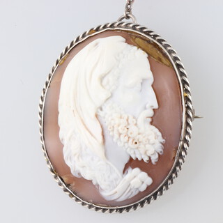 A 19th Century cameo portrait brooch of a gentleman in a silver frame, signed on the reverse 