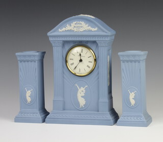 A Wedgwood blue Jasperware timepiece 22cm together with a pair of square candlesticks 15cm 
