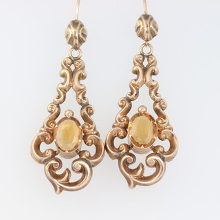 A pair of Victorian yellow metal scroll earrings set with oval citrines, 5 grams, 55mm 