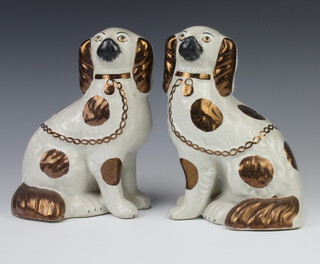 A pair of Victorian style Staffordshire Spaniels with ochre decoration 20cm 