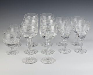 A suite of table glassware comprising 6 hocks, 4 wines and 2 brandy glasses, all engraved with flowers 
