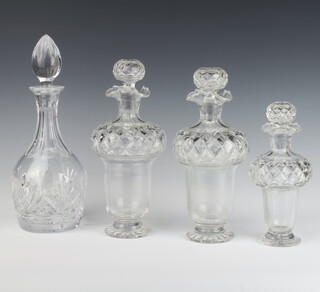 A pair of cut glass thistle shaped decanters and stoppers 26cm (1 chipped lip), a smaller ditto 19cm and a mallet shaped ditto 30cm