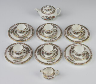 A Wedgwood miniature tea set comprising teapot, milk jug (a/f), 6 tea cups, 6 saucers and 6 small plates together with a display rack 