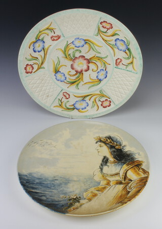An Art Deco moulded polychrome dish decorated with flowers 42cm, an Edwardian charger decorated with a lady 41cm 