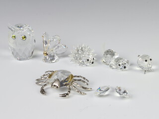 A Swarovski Crystal figure of a puppy 1cm, a baby hedgehog 2cm, an owl 4cm, a piglet 2cm, a butterfly 3cm and a glass figure of a crab 7cm.