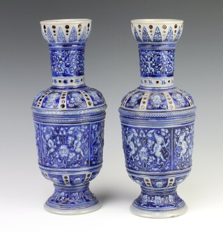 A pair of late 19th Century German stoneware oviform vases decorated with panels of cavorting figures with mask detail 31cm 