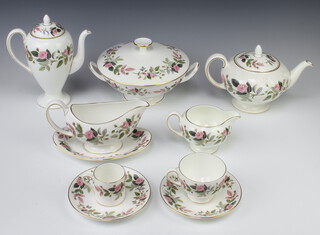 An extensive Wedgwood Hathaway Rose pattern tea, coffee and dinner service comprising 17 coffee cans, 17 saucers, 28 tea cups, 37 saucers, 4 two handled soup bowls, 8 saucers, 9 small tea cups, 2 sugar bowls, teapot, coffee pot, 3 cream jugs, 6 milk jugs, 43 small plates, 10 side plates, 17 medium plates, 8 small dinner plates, 26 large dinner plates, 3 vegetable tureens and covers, 2 vases, a sauce boat and 2 stands, small jug, 1 large tea cup, 2 bowls, 2 dishes, 2 napkin rings and a dish, 7 soup bowls  