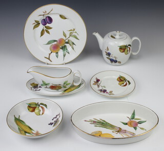 A service of Worcester Evesham tableware comprising 12 small plates, 8 dinner plates, 8 dessert bowls, 3 lidded dishes, 2 souffle dishes, 6 bowls, a sauce boat and stand, 2 lids and a teapot 