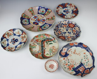 A 19th Century Imari scalloped dish decorated with flowers 22cm, ditto 21cm, another 22cm, a scalloped ditto 26cm, a dish 30cm, a famille verte dish decorated with a figure and horse beneath a tree 22cm (star crack) and a 19th Century tea bowl cover 8cm 