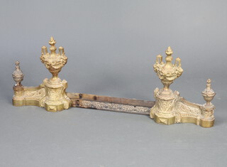 A pair of French 19th Century gilt metal andirons in the form of lidded urns 34cm h x 28cm w x 12cm d together with an associated pierced gilt metal fender front 8cm x 66cm 