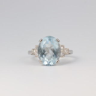 A platinum aquamarine and diamond ring, the centre oval stone 4.5ct, the 6 brilliant cut diamonds 0.18ct, size O 