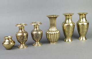 Two pairs of benares brass club shaped vases 8cm x 3cm and 15cm x 7cm, a Benares brass squat shaped vase 8cm x 4cm and a ditto club shaped vase 17cm x 9cm 