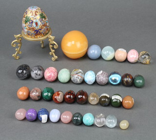 A champleve enamel model egg 6cm x 5cm, together with 36 other polished hardstone eggs 