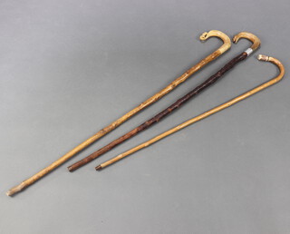 A crook with horn handle, 1 other crook and a walking stick with stag horn handle incorporating a whistle (3) 