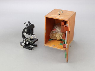 A Cooke, Troughton and Simms Ltd. no.M3074 1.5x binocular microscope, together with a collection of lenses, cased 