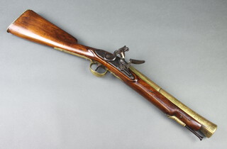 William Hutchinson, a flintlock brass barrelled musketoon, the 35cm barrel with formed rear sight proof marks and marked 5KS1292, the steel lock marked Hutchinson with steel ram rod and brass butt piece marked 5KS1292 75cm overall 