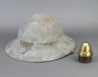 A British brass shell nose cone marked NO101-11 8cm h x 6cm diam., together with a Second World War fire watcher's helmet marked 41 complete with liner (light rust to the top, retaining straps missing in places) 