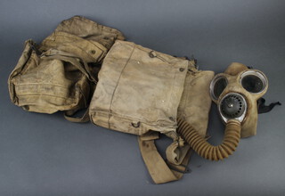 A military issue respirator in canvas bag together with 1 other canvas bag