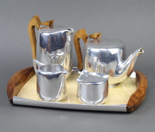 A five piece Picquot Ware tea service comprising twin handled tray 40cm x 28cm, circular teapot 12cm h, hot water jug 17cm, cream jug 9cm, lidded sugar bowl 7cm  