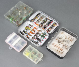 An Orvis dry fly box with fishing flies, a Wheatley fly box and 3 other fly boxes 