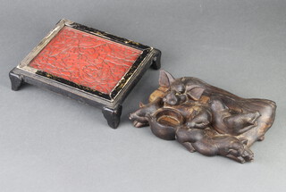 A Chinese carved hardwood figure of a reclining sow and piglets 5cm x 22cm x 14cm together with a light oak cinnabar and black lacquered rectangular stand decorated dragonflies 4cm x 22cm x 18cm 